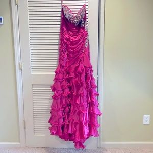 Mac Duggel prom dress size 10 strapless with a corset back. The color is fushia.